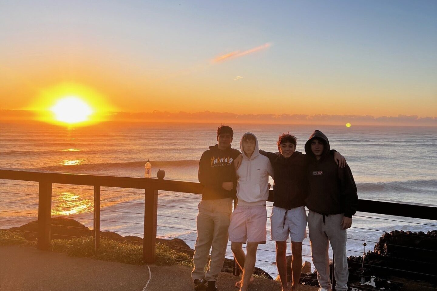 Quatre étudiants devant l’océan au coucher du soleil en Australie-Méridionale.