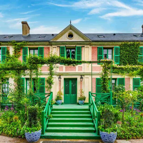 Claude Monet's colourful house in Giverny surrounded by flowers and lush gardens