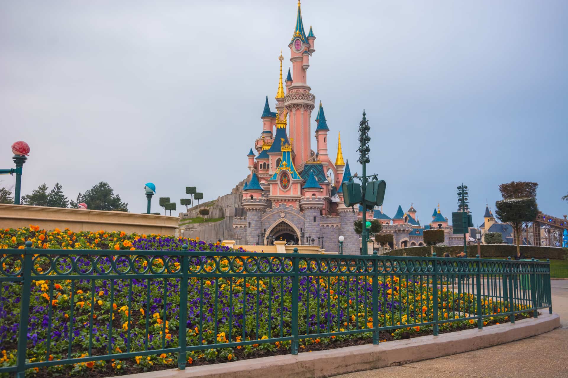 Sleeping Beauty Castle at Disneyland Paris surrounded by colourful gardens