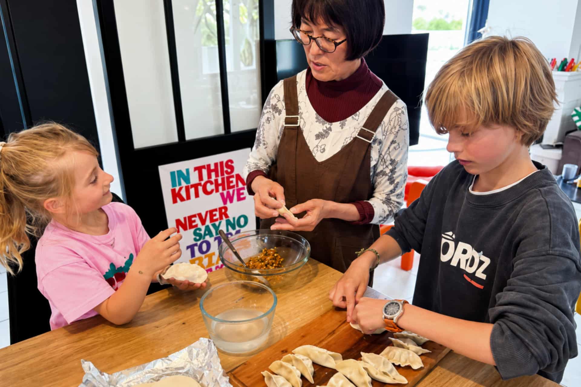 Adult sharing a language activity with children in a French host family